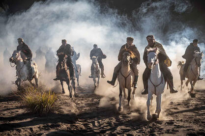 Spirits in the Dust A group of Tengger horsemen riding at the foot of the Bromo volcano Buy Now