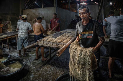 Yellow Gold People at work in a noodle factory © Roberto Pazzi