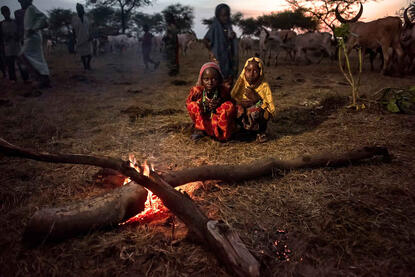 Sunset on the Nomadic Camp Boudouma children warming up at the fire © Roberto Pazzi