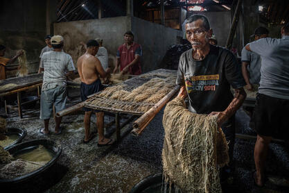 Yellow Gold People at work in a noodle factory © Roberto Pazzi