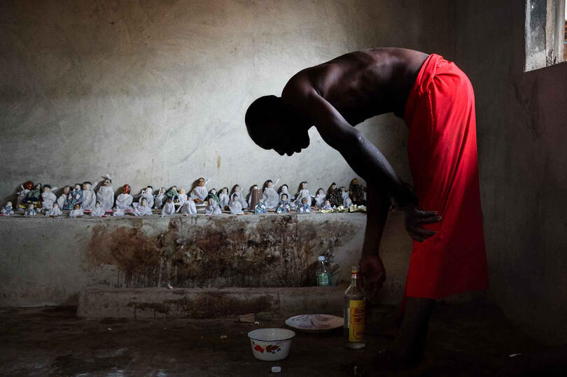 Mourning Ritual Portrait of a Vodun priest during an offering to the Venavi dolls © Roberto Pazzi
