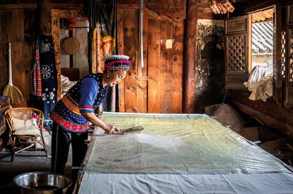 Batik Bai woman working on indigo-dyed batik textiles in her workshop © Roberto Pazzi