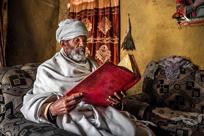 The Holy Book Portrait of an Orthodox priest reading a holy book in his house © Roberto Pazzi