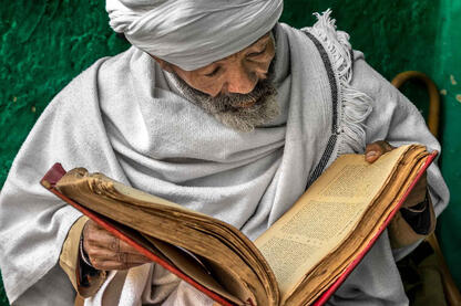 Sacred Text Portrait of an Orthodox priest reading a holy book written in ge'ez alphabet © Roberto Pazzi