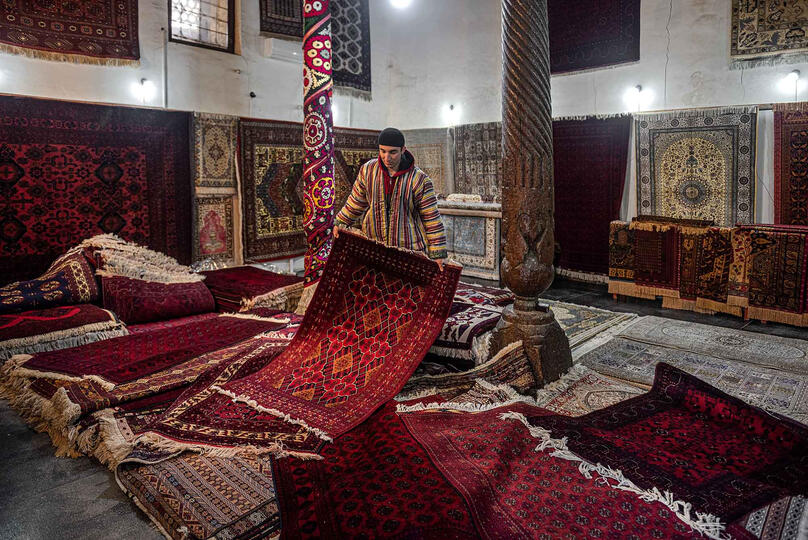 The Carpet Seller Portrait of a young carpet seller in his family shop © Roberto Pazzi